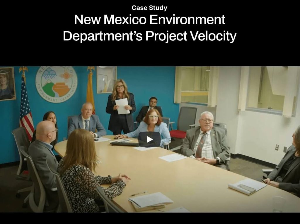 Screen capture of the Apaluma website home page. There is a black background with white text at the top that says Case Study: New Mexico Environment Department's Project Velocity. Below it is a video embedded, and the video still shows members of the department and Alicia Keyes, the founder and CEO of Apaluma. They appear to be in a state office with the department seal behind them. 